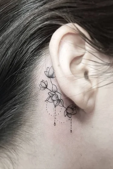 Fine Line Minimalist floral tattoo design for women behind the ear