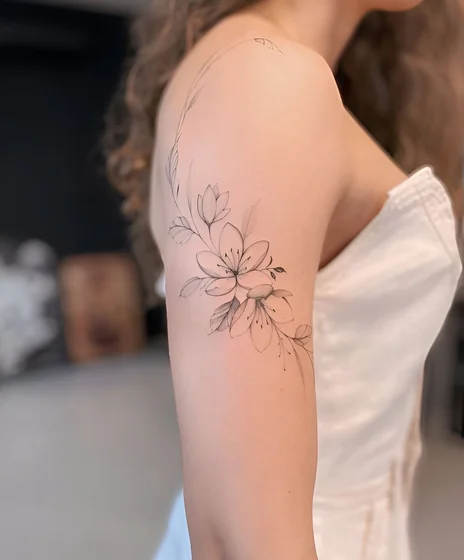 Fine Line Sketch floral flower tattoo design for women on upper arm
