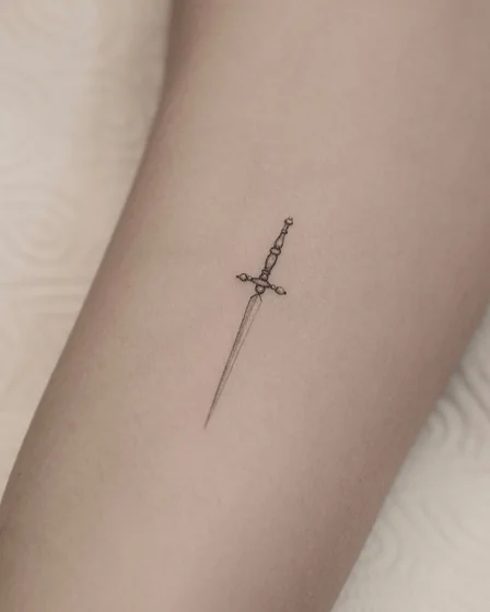 Fine Line minimalist sword tattoo design for men