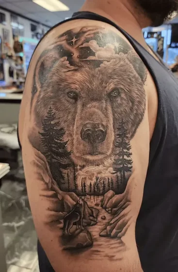 Realistic bear, wolf, and tree tattoo design for men on arm