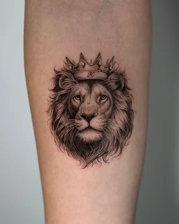 Realistic fine line lion with crown tattoo idea for men and women on upper arm